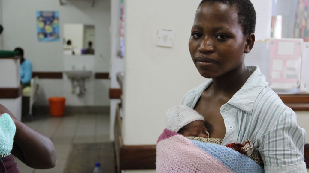 photo of a woman holding a baby