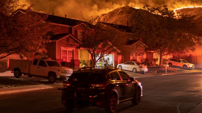 A photograph of flames near houses in Chino Hills, Calif., during the 2020 Blue Ridge Fire