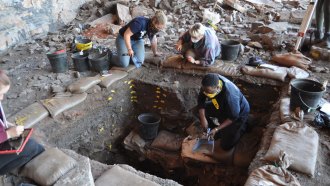 scientists excavating a rock shelter in the Kalahari Desert