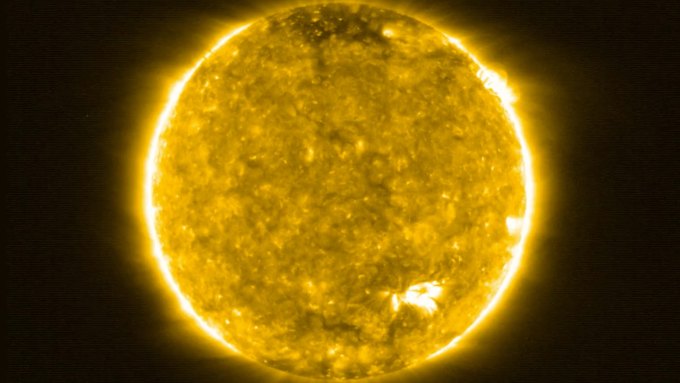 A false-color image of the sun in ultraviolet light showing flares and eruptions breaking from its surface