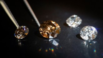 Four diamonds of varying hues are shown on a black background