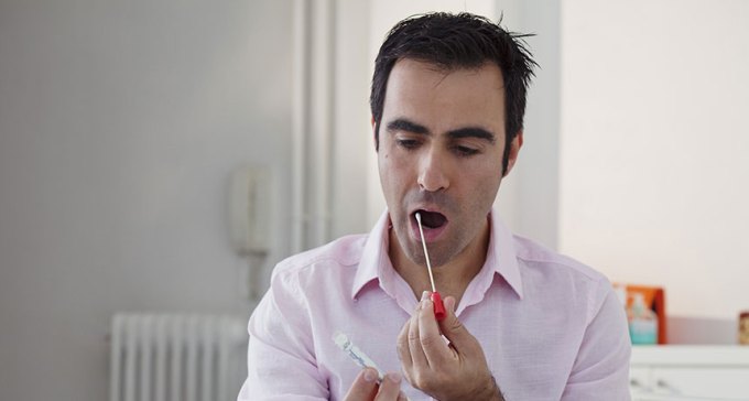 man swabbing his cheek