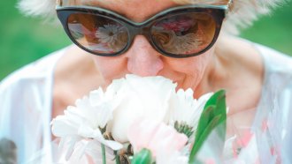 woman smelling a flower