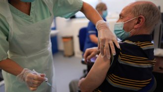 older man receiving coronavirus vaccine injection