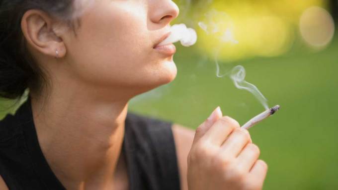 a photo of a person smoking marijuana