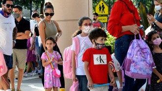 Parents and kids lined up outside a school