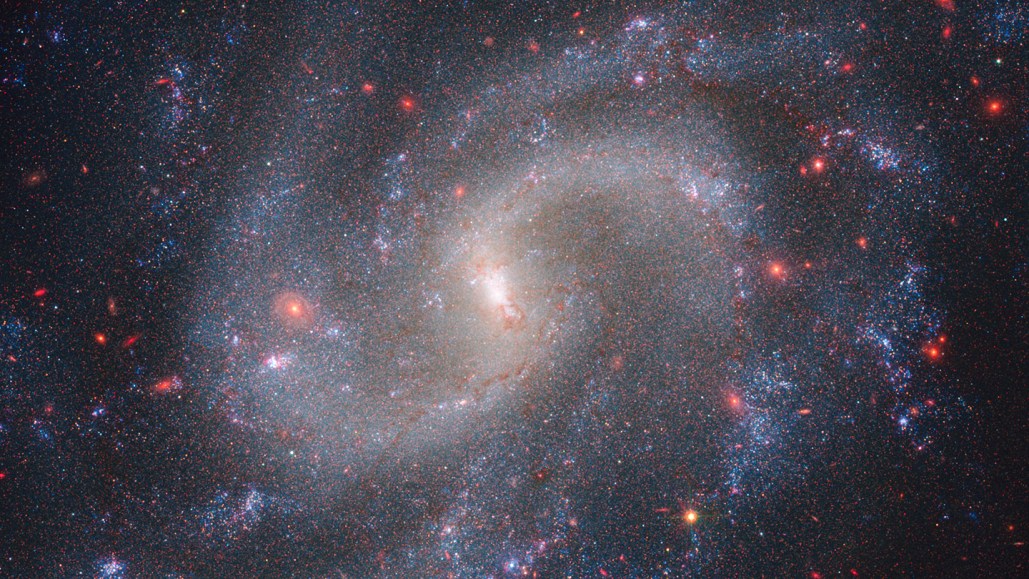 A spiral galaxy shown in a composite image from the James Webb Space Telescope and Hubble Space Telescope