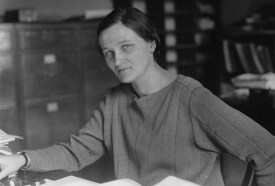 black and white photo of Cecilia Payne seated at a desk looking at the camera