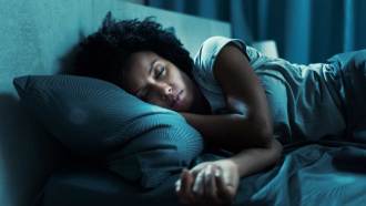 A photo of a women asleep in a bed