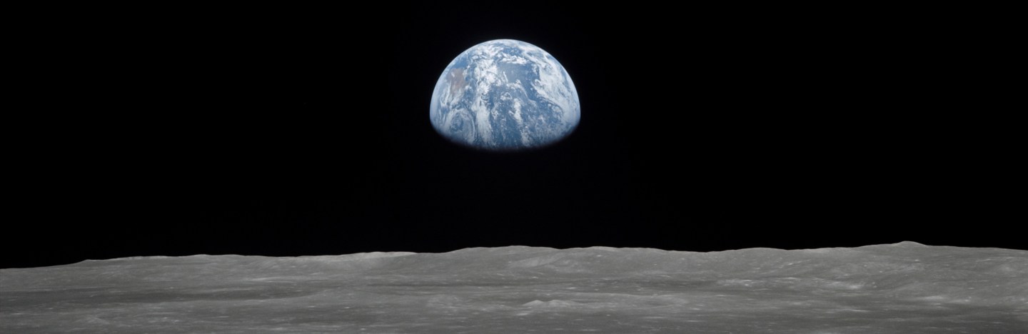 Earth rising over moon's horizon